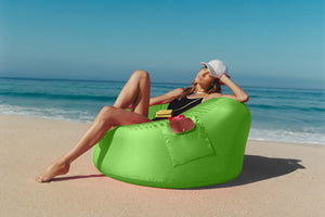 Girl Sitting on a Green Fatboy x Longchamp Chair on the Beach