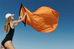 Girl Inflating an Orange Lamzac O