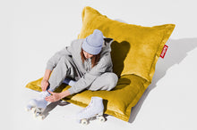Load image into Gallery viewer, Girl Sitting on a Gold Honey Fatboy Original Slim Recycled Velvet Bean Bag Chair
