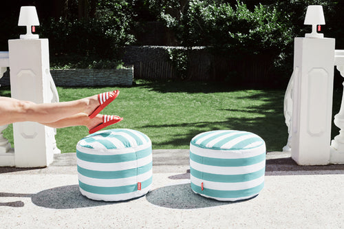 2 Stripe Azur Fatboy Point Outdoor Ottomans on a Patio