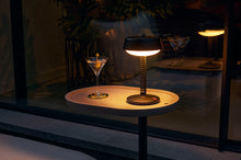 Load image into Gallery viewer, Anthracite Fatboy Bellboy Lamp on a Brick Table at Night
