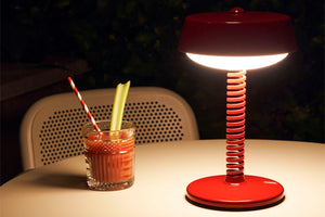 Lobby Red Fatboy Bellboy Lamp on a Dining Table at Night