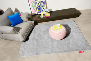 Cloudy Grey Fatboy Dot Carpet Next to a Sumo Loveseat and a Humpty Dumpty Table