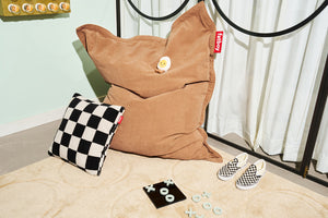 Creamy Camel Fatboy Dot Carpet in a Room Next to a Slim Teddy Bean Bag