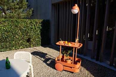 Tangerine Fatboy Jolly Trolley on a Patio