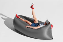 Load image into Gallery viewer, Girl Laying on a Steel Grey Fatboy Lamzac Version 3.0 Inflatable Lounger
