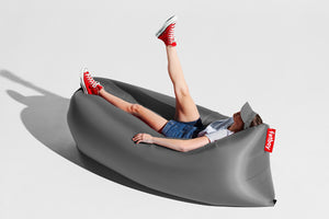 Girl Laying on a Steel Grey Fatboy Lamzac Version 3.0 Inflatable Lounger