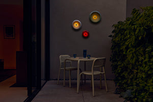 Multi Fatboy Oloha Trio Hanging on a Patio Wall at Night