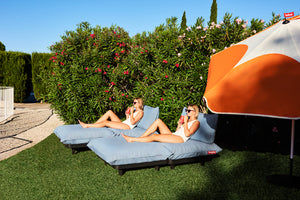 Girls Sitting on Storm Blue Fatboy Daybed Loungers on a Lawn