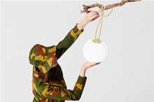 Load image into Gallery viewer, Girl Hanging a Sandy Beige Fatboy Bolleke Wireless Hanging Lamp on a Tree
