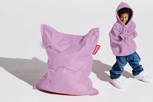 Boy Standing Next to a Lilac Fatboy Junior Bean Bag Chair