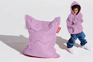 Boy Standing Next to a Lilac Fatboy Junior Bean Bag Chair