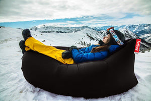 Girl Laying on a Black Lamzac in the Snow