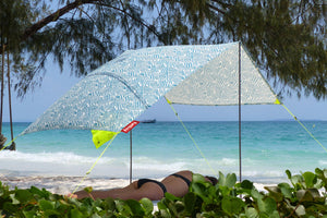 Woman Laying Under a Bali Fatboy Miasun Sun Shade on the Beach