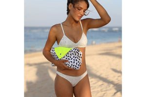 Girl Carrying a Folded Capri Fatboy Miasun Sun Shade on the Beach