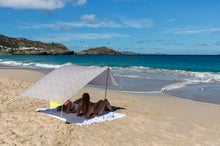 Load image into Gallery viewer, Two Ladies Laying Under a Comporta Fatboy Miasun Sun Shade on the Beach
