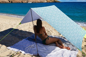 Girl Laying Under a Lisboa Fatboy Miasun Sun Shade Setup on the Beach