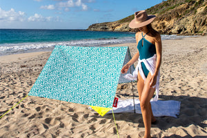 Girl Standing Next to a Minorca Fatboy Miasun Sun Shade Setup on the Beach