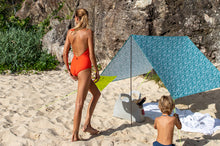 Load image into Gallery viewer, Woman and Her Child Standing Next to a Minorca Fatboy Miasun Sun Shade Setup on the Beach
