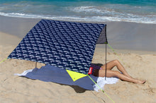 Load image into Gallery viewer, Girl Laying Under a Mochi Fatboy Miasun Sun Shade Setup on the Beach
