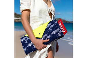 Woman Carrying a Folded Mochi Fatboy Miasun Sun Shade on the Beach