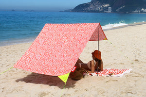 Girl Laying Under a Palm Beach Fatboy Miasun Sun Shade on the Beach