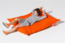 Load image into Gallery viewer, Guy Laying on an Orange Fatboy Original Bean Bag
