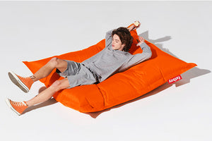 Guy Laying on an Orange Fatboy Original Bean Bag