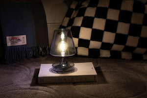 Grey Fatboy Transloetje Lamp Sitting on a Book