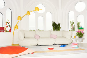 Bubble Pink Puff Weave Rolster Pillows on a Limestone Sumo Sofa Grand
