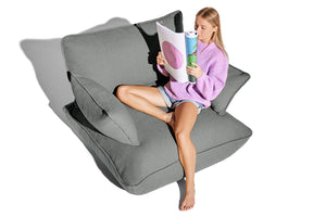 Model Sitting in a Mouse Grey Fatboy Sumo Loveseat
