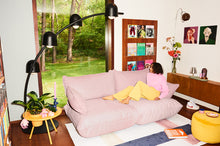 Load image into Gallery viewer, Model Sitting on a Bubble Pink Fatboy Sumo Sofa Medium in a Living Room
