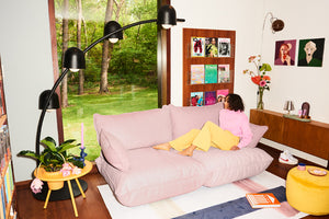 Model Sitting on a Bubble Pink Fatboy Sumo Sofa Medium in a Living Room