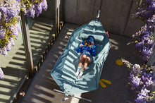 Load image into Gallery viewer, Model Laying on a Seafoam Fatboy Headdemock Superb Hammock
