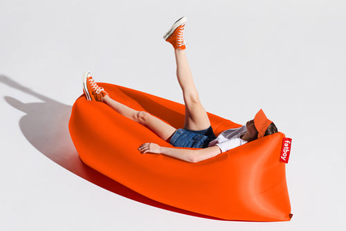Girl Laying on an Orange Fatboy Lamzac the Original