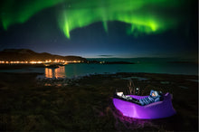 Load image into Gallery viewer, Person Laying on a Purple Fatboy Lamzac the Original Under the Northern Lights
