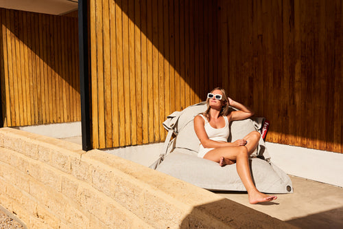 Model Sitting on a Mist Buggle-Up Outdoor