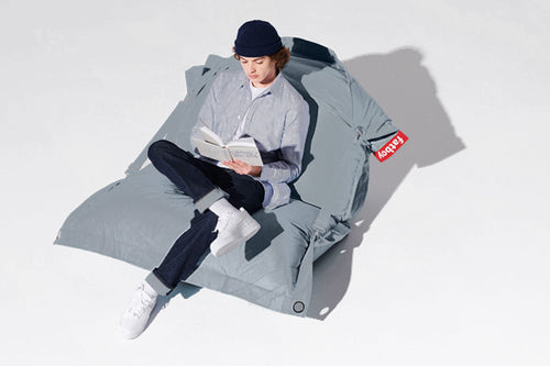 Model Sitting on a Storm Blue Buggle-Up Outdoor