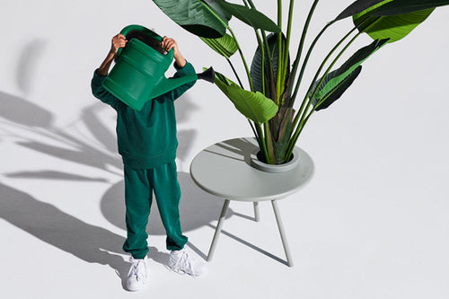 Boy Watering a Plant in a Light Grey Fatboy Bakkes Side Table