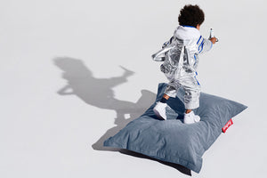 Boy in an Astronaut Costume Standing on a Fatboy Junior Stonewashed Bean Bag Chair