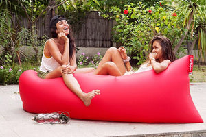 Two Girls Laying on a Red Fatboy Lamzac