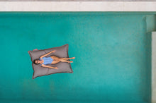 Load image into Gallery viewer, Model Floating on a Grey Taupe Fatboy Floatzac in the Pool
