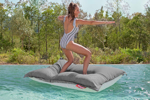 Model Standing on a Rock Grey Fatboy Floatzac in a Pool