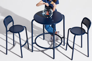 Model Feeding Fish on a Dark Ocean Fatboy Toni Haute Bistreau Table