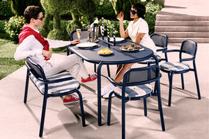 Models Sitting at Dark Ocean Fatboy Toni Tavolo Outdoor Dining Table and Chairs
