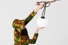 Load image into Gallery viewer, Model Hanging an Anthracite Fatboy Bolleke Lamp on a Tree Branch
