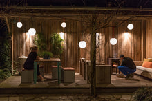 Load image into Gallery viewer, Fatboy Bolleke Lamps Hanging on a Patio at Night
