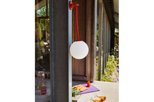 Load image into Gallery viewer, Red Fatboy Bolleke Lamp Hanging on a Hook Outside
