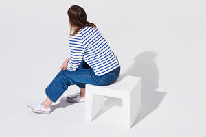 Model Sitting on White Fatboy Concrete Seat