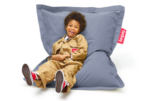 Boy Sitting on a Blue Fatboy Junior Stonewashed Bean Bag Chair